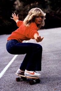Farrah Fawcett in flared jeans and some kind of button up sweater. (who knows?)